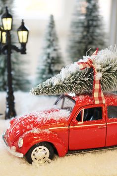 a red car with a christmas tree on top