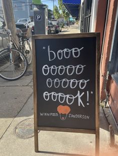 a sign on the sidewalk that says booooooo good cook