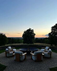 a table and chairs sitting on top of a gravel field