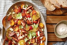 a platter filled with lots of different types of food on top of a wooden table