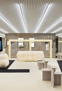 the interior of a modern fashion store with white furniture