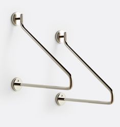 two metal hooks on the side of a wall