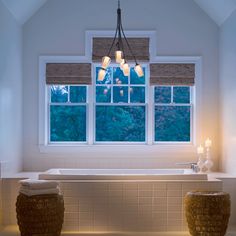 a bath room with a tub and a window