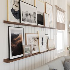 a living room with pictures on the wall