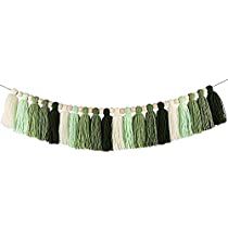 green and white tasselled garland hanging from a string