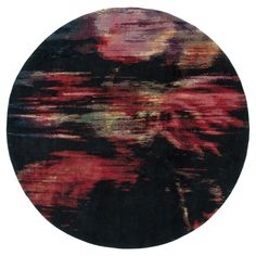 a round rug with an abstract design in black, red and yellow colors on it