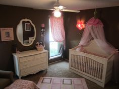 a baby's room with two cribs, a dresser and a mirror