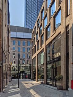 an empty city street with tall buildings in the background