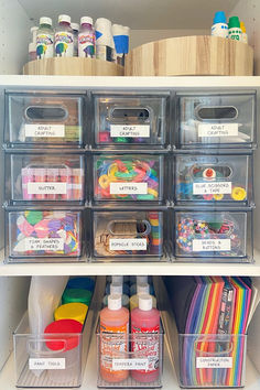 an organized craft closet with clear bins filled with supplies