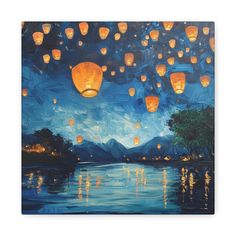 a painting of lanterns floating in the air over a body of water with trees and mountains behind it