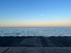 an empty dock with the ocean in the background