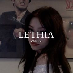 a woman with long hair standing in front of a poster that says lethia obrion