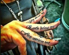 two people with tattoos on their hands and one has the words earth below them,