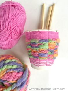 two balls of yarn and knitting needles next to each other