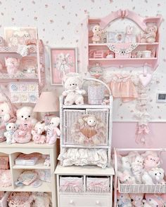 a room filled with lots of pink and white stuff animals in baskets on top of shelves