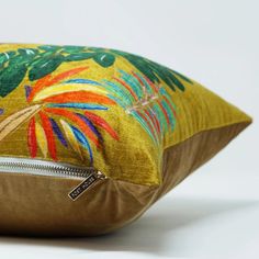 a close up of a pillow on a white surface with a zippered pouch in the middle