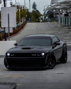 a black sports car is parked on the street