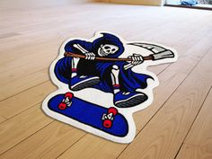 a sticker depicting a skeleton on a skateboard