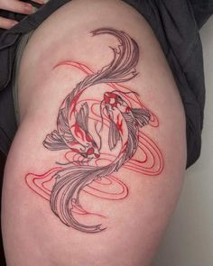 a woman's thigh with a koi fish tattoo on it