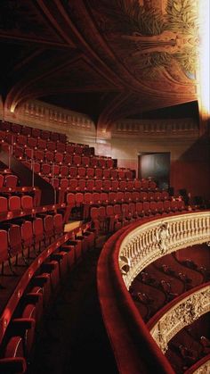 an empty auditorium with red seats and ornate railings