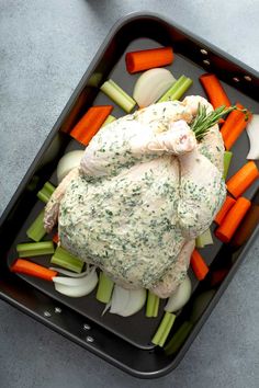 a tray with chicken, carrots and celery in it on a table