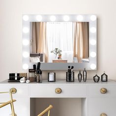 a white desk with a mirror and lights on it