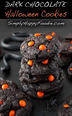 chocolate halloween cookies stacked on top of each other with orange and black sprinkles