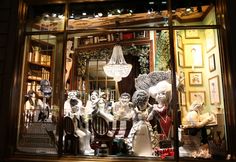 a window display with many statues in it