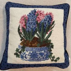 a blue and white pillow with flowers on it