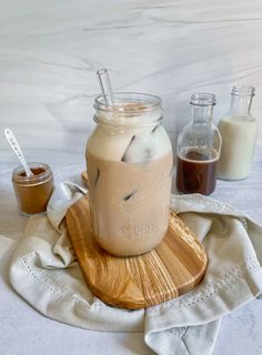 a mason jar filled with liquid sitting on top of a wooden cutting board