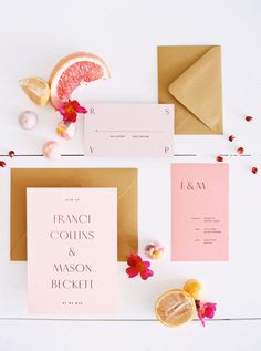 the wedding stationery is laid out on top of each other, including an orange slice