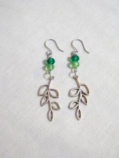 These earrings are made with faceted green glass beads and a leaf charm. The ear wires were made with galvanized steel wire. Leaf Charms, Metal Charm, Green Leaf, Galvanized Steel, Charm Earrings, Green Glass, Ear Wires, Green Leaves, Jewelry Earrings Dangle