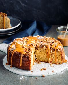 a bundt cake with caramel drizzled on top and one slice cut out