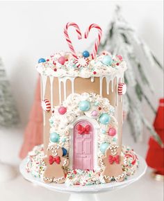 a gingerbread house decorated with candy canes and candies