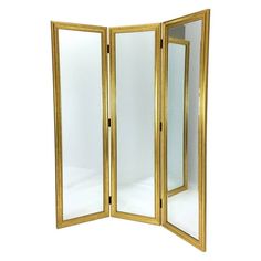 an open gold colored folding screen with mirrors on the front and back sides, set against a white background