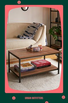 a coffee table with books on it in front of a couch