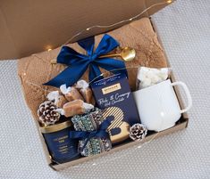 a gift box filled with coffee, marshmallows, cookies and other items