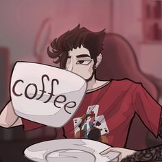 a man sitting at a table holding a plate with the word coffee written on it