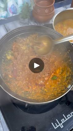 two bowls filled with food sitting on top of a stove