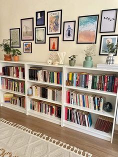 the bookshelf is full of many different types of books and pictures on the wall