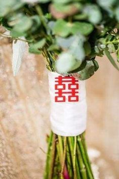 a bunch of flowers that are sitting on some kind of table cloth with the word love written on it