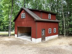 a red barn with a garage attached to it