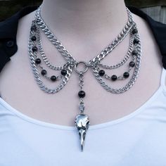 Featuring a stainless steel corvidae bird skull charm this layered gothic necklace is a serious statement piece. The obsidian charms both above the centrepiece  and on the chains provide a mystique to this necklace. The O-ring in the middle brings the design together and balances this amazing layered choker. A gothic necklace that brings extra attention to your neckline, and can spice up even the most boring tank top.  This necklace comes in 2 lengths:  - choker (shorter length and would sit at Alternative Necklace, Skull Choker, Gothic Choker Necklace, Gothic Chokers, Tiered Necklace, Raven Skull, Alternative Jewelry, Layered Chokers, Beaded Necklace Diy