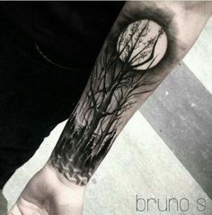 a man with a tree tattoo on his arm