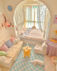 a child's bedroom is decorated in pastel colors and features an arched window