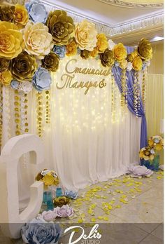 an image of a decorated stage with flowers on the wall and balloons in the air