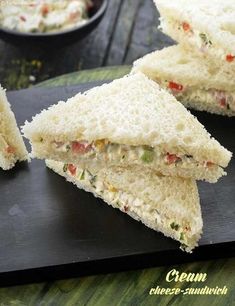 two sandwiches cut in half on a cutting board