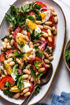 a white plate topped with beans and tomatoes