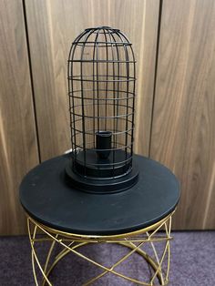 a bird cage sitting on top of a table