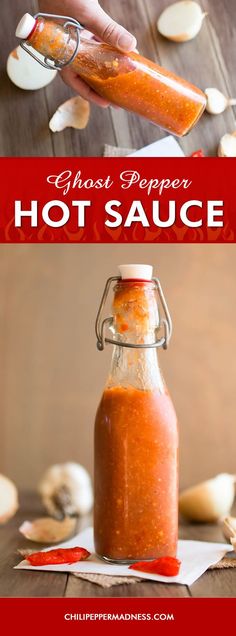 a person pouring hot sauce into a glass jar on top of a wooden table with garlic cloves